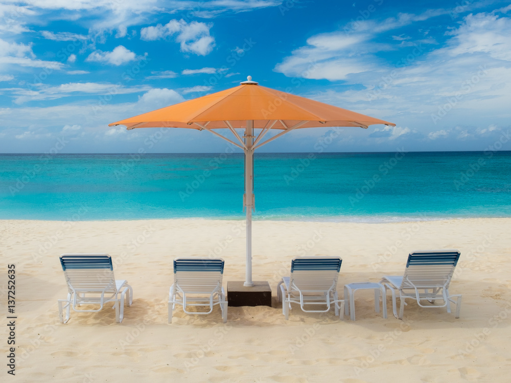 Parasol and sun loungers on Seven Mile Beach in the Caribbean, Grand Cayman, Cayman Islands Parasol and sun loungers on Seven Mile Beach in the Caribbean, Grand Cayman, Cayman Islands