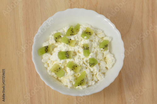 Soft cheese with pieces of fruit, kiwi.