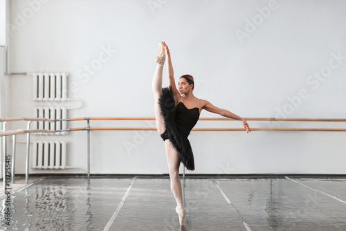 Skill ballet dancer shows stretching in class