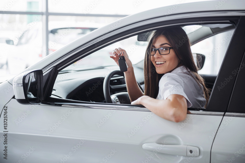 Young happy woman near the car with keys in hand Young happy woman near the car with keys in hand