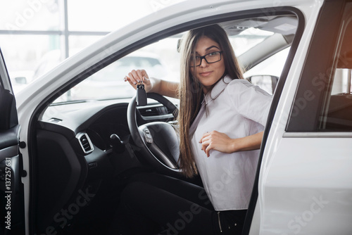 Young happy woman near the car with keys in hand © standret