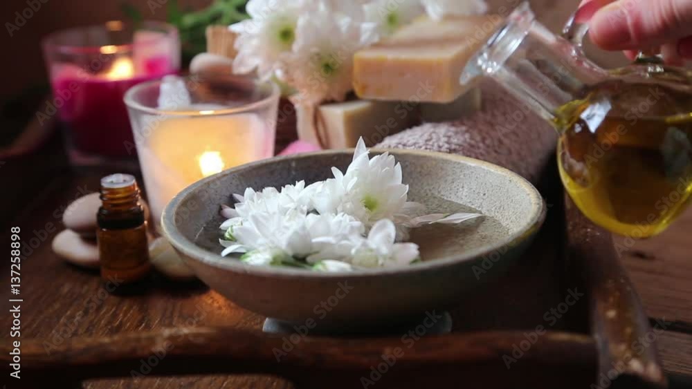 Spa setting.Adding olive oil in the water for skin treatments .Burning candles and aromatherapy Spa setting.Adding olive oil in the water for skin treatments .Burning candles and aromatherapy