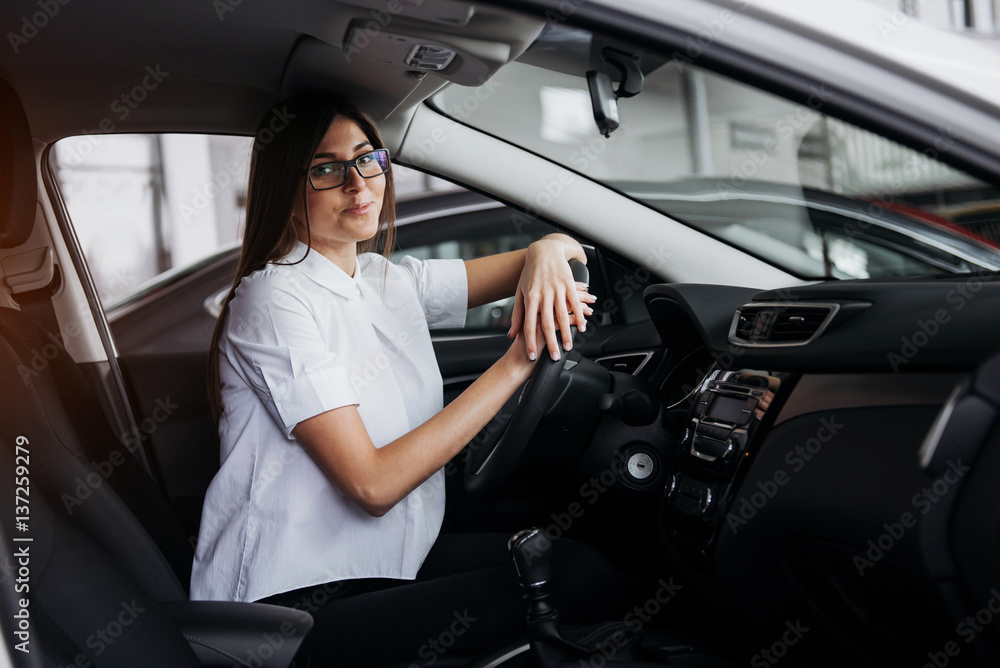 portrait of young beautiful woman sitting in the car