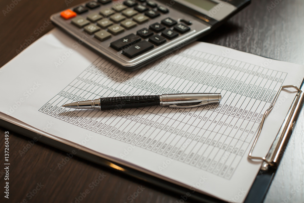 Accounting documents, pens and calculator closeup Accounting documents, pens and calculator closeup