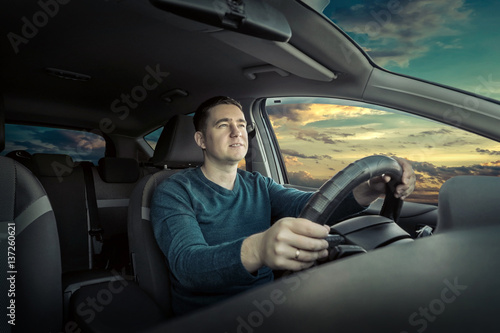 Man sitting and driving in the car. © Andrii IURLOV