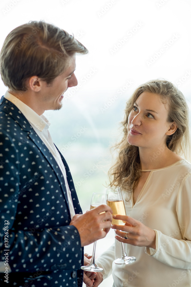 Happy lovers clinking glasses and holding hands Happy lovers clinking glasses and holding hands