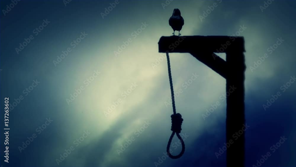 Raven Standing on a Gallows with a Swinging Noose on a Cloudy Day Raven Standing on a Gallows with a Swinging Noose on a Cloudy Day