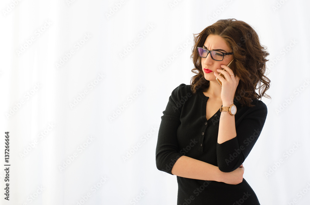 Attractive, professional business woman talking on the phone on a white background Attractive, professional business woman talking on the phone on a white background