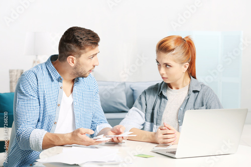 Young couple calculating taxes at home