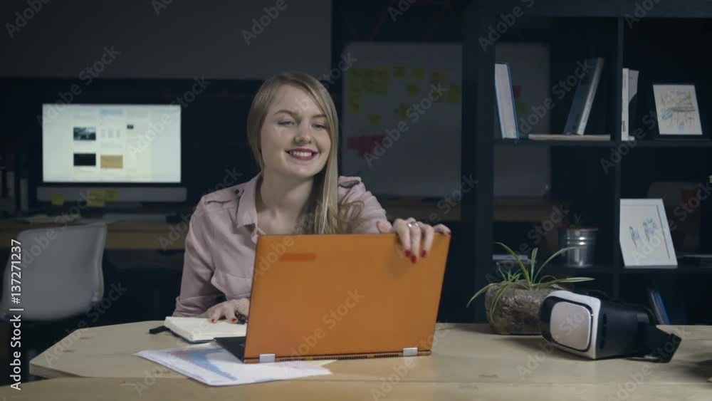 Young woman finishes work in office Young woman finishes work in office
