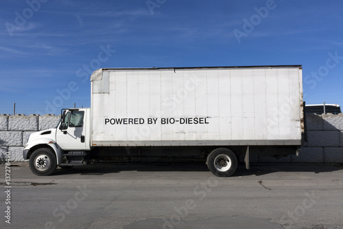 Side view of BIO-DIESEL powered truck parked under blue sky.