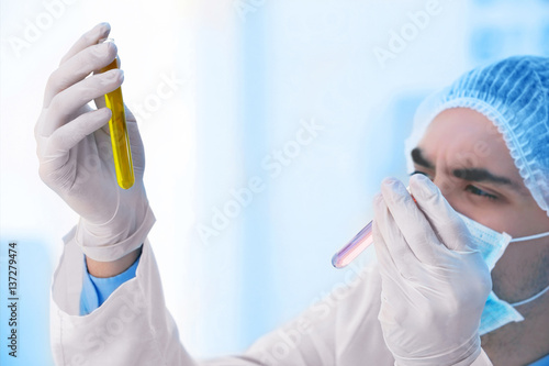 Young male scientist making...