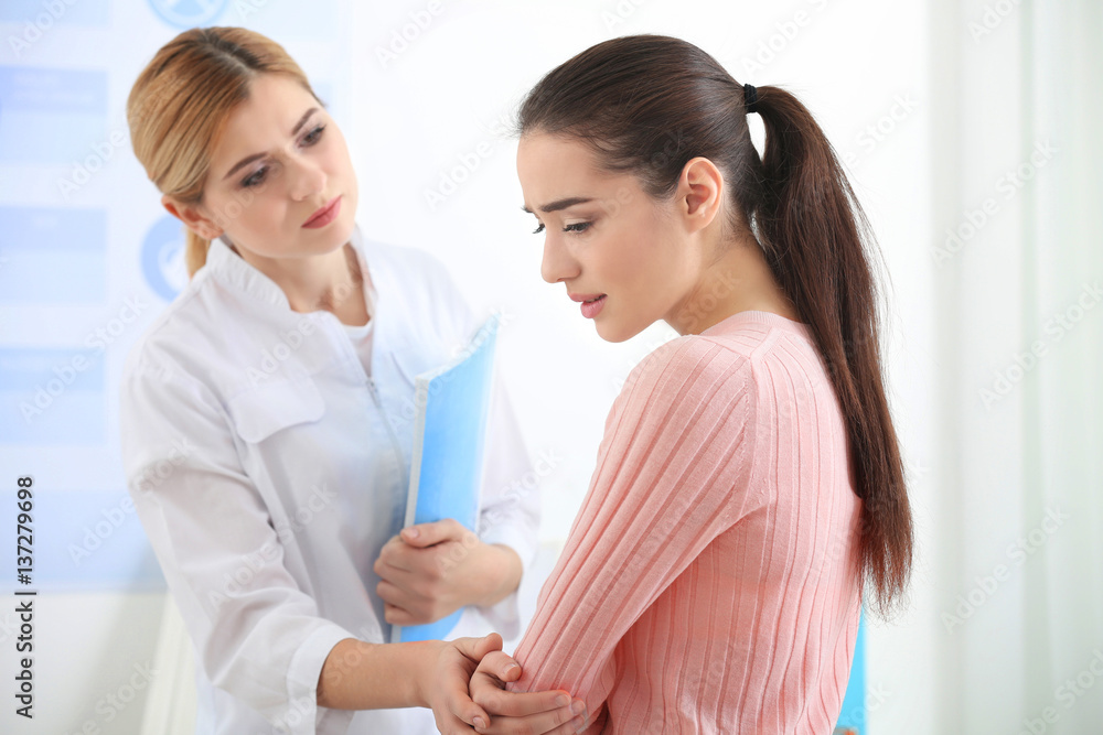 Young depressed woman at doctor's office