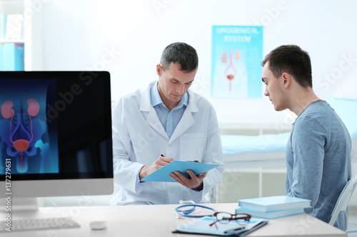 Man with urology problem visiting doctor at hospital photo