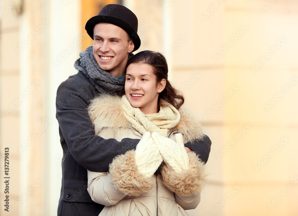 Young couple embracing on the street Young couple embracing on the street