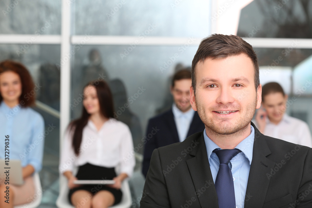 Job interview concept. Businessman standing in office hall Job interview concept. Businessman standing in office hall
