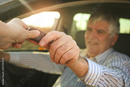 Senior man holding a car key.