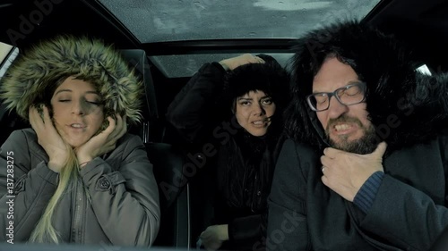 Three people freezing feeling cold in car in winter