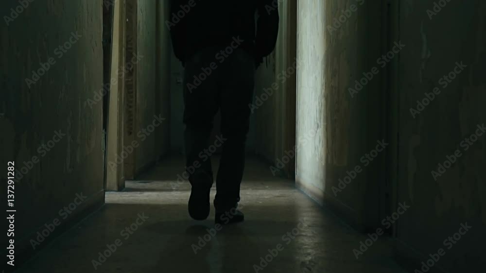 Following a hooded young man inside a dark derelict ghetto building,slow motion dramatic Following a hooded young man inside a dark derelict ghetto building,slow motion dramatic