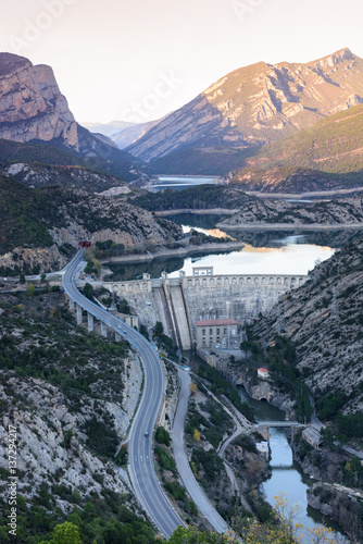 View of hydro-electric power station and a highway. Dam at Sege river, Oliana, Spain, Europe. Mountain peaks landscape. photo