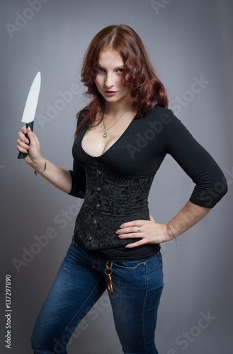 red-haired girl holding a knife