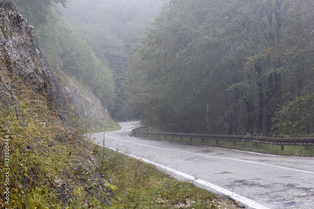 mountain road with fog and rain