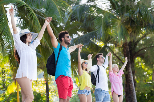 Young People Group Holding Hands Up Tropical Park Palm Trees Happy Smiling Friends Holiday Summer Vacation Ocean Travel photo