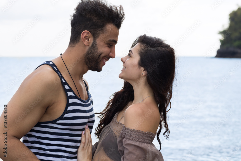 Couple On Beach Summer Vacation, Beautiful Young Happy People In Love, Man And Woman Smile Holding Hands Sea Ocean Holiday Travel Couple On Beach Summer Vacation, Beautiful Young Happy People In Love, Man And Woman Smile Holding Hands Sea Ocean Holiday Travel