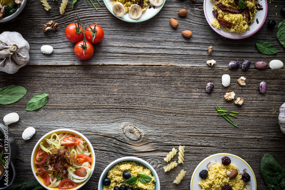 Food and Ingredients with Empty Space for Designs on Wooden Background. Overhead Shot. Food and Ingredients with Empty Space for Designs on Wooden Background. Overhead Shot.