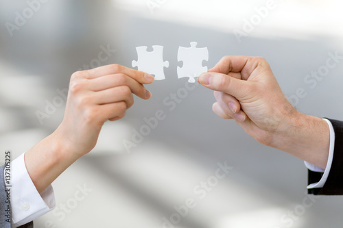 Photography man and woman hand holding jigsaw puzzles