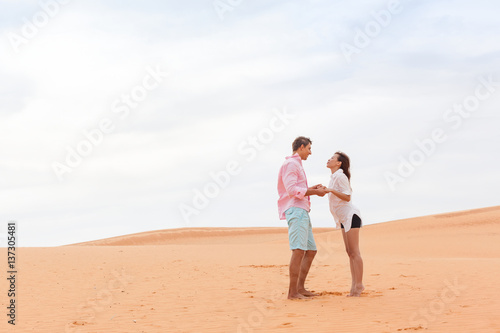 Young Man Woman In Desert Beautiful Couple Asian Girl And Guy Hold Hands Sand Dune Landscape Background
