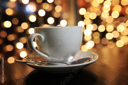 cup of coffee on the table on blured background with circle bokeh