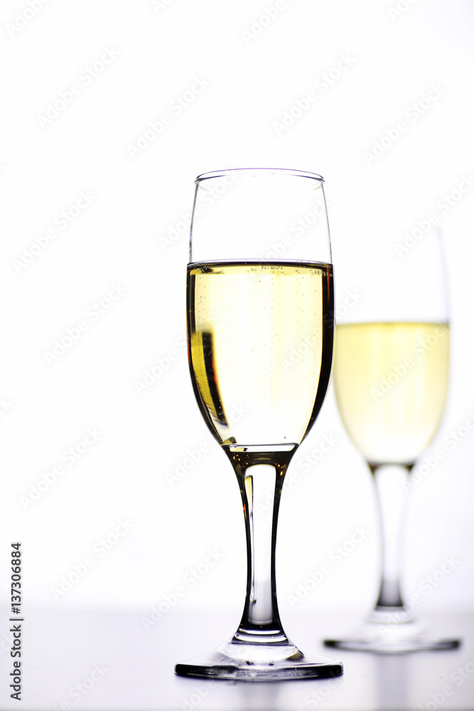 glass of white wine on a table on white background isolate