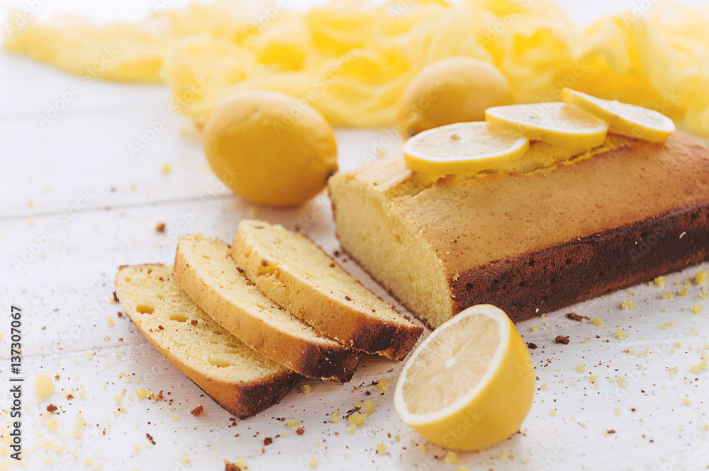 lemon cake with fruits on white wooden surface