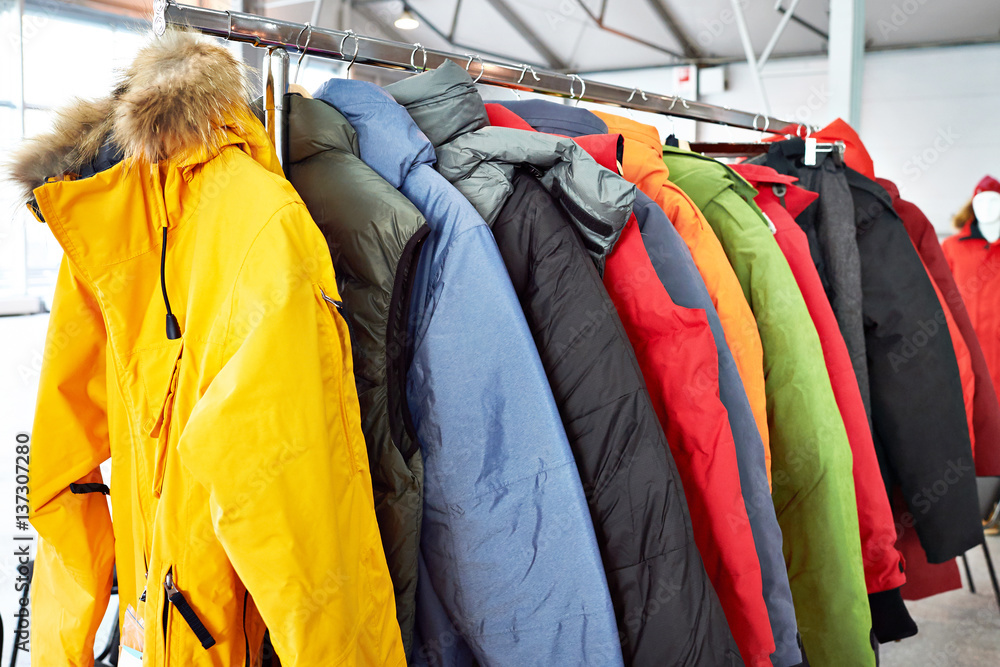 Winter ski sports jacket on hanger in  store - obrazy, fototapety, plakaty 
