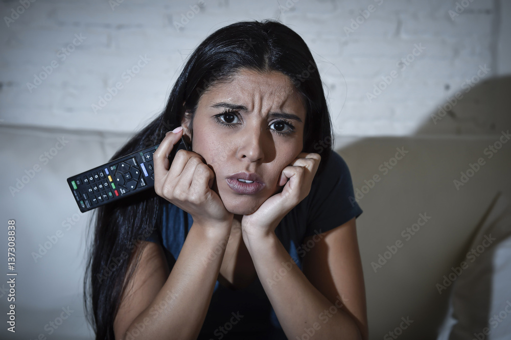 Naklejka premium woman at home sofa couch in living room watching television very concentrated and focused