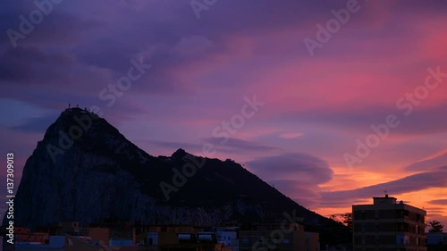 Colorful dusk time-lapse of Gibraltar Rock and La Linea de la Concepcion cityscape in Spain.