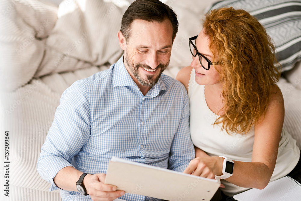 Delighted couple expressing positive emotions at home
