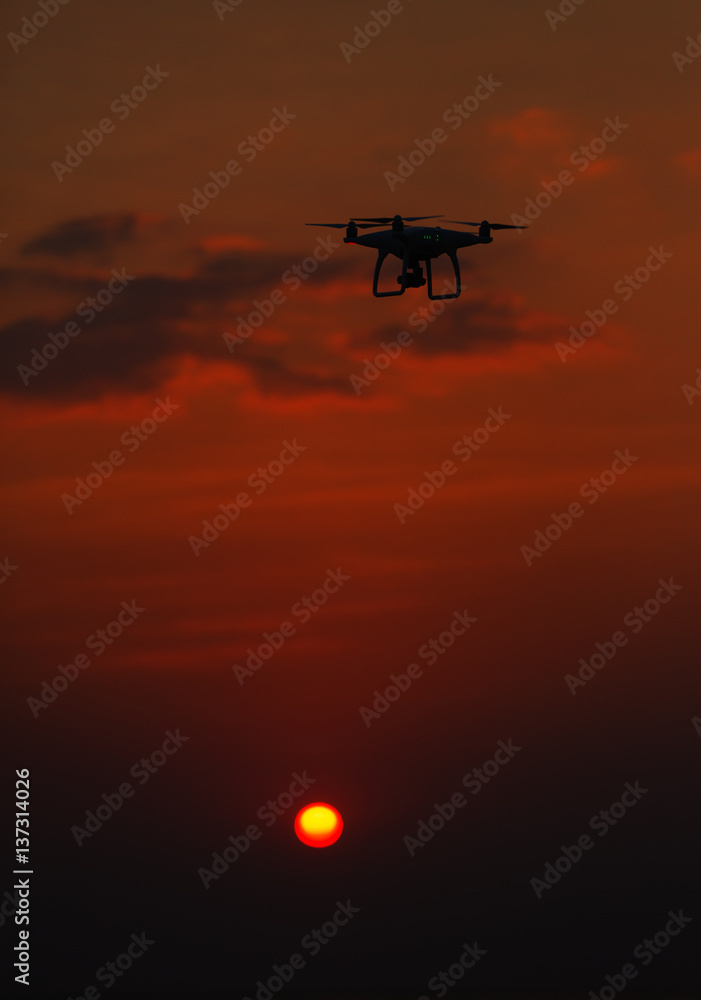 flying drone quadrocopter at sunset flying drone quadrocopter at sunset