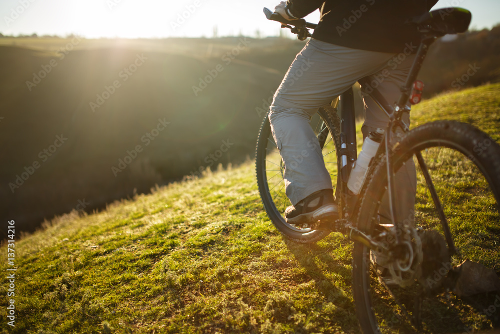 Obraz premium closeup of rear wheel sports bike. race mountainbike on the hill.