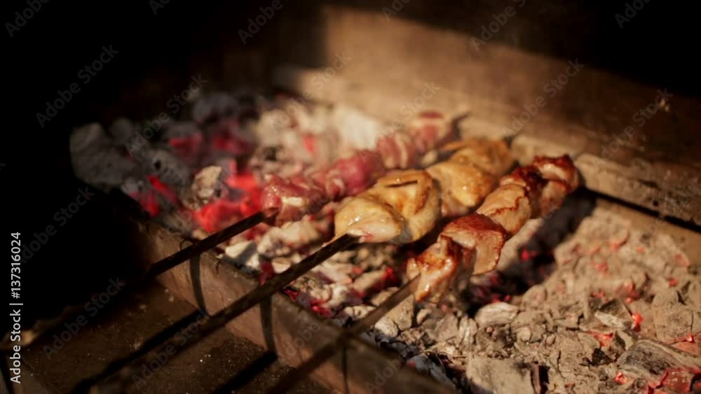 Process of cooking the shish kebab on coals on the grill Process of cooking the shish kebab on coals on the grill