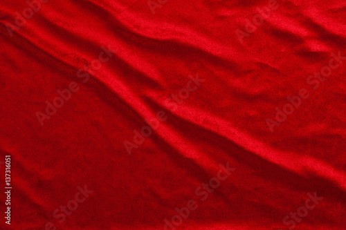 Flowing red luxury shiny fabric textile material for texture background