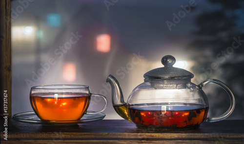 Black tea on the window sill. Hot tea. Black Tea leaves at the bottom of the cup. Tea time. Winter.