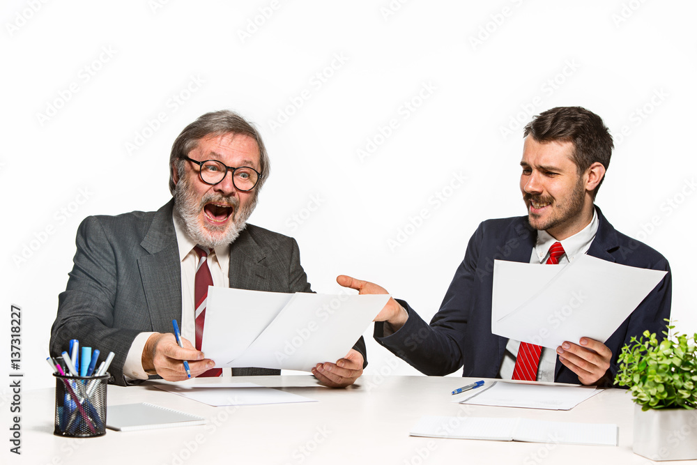 The two colleagues working together at office on white background. The two colleagues working together at office on white background.