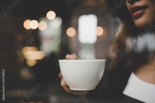 Young woman relaxing drinking coffee at cafe.