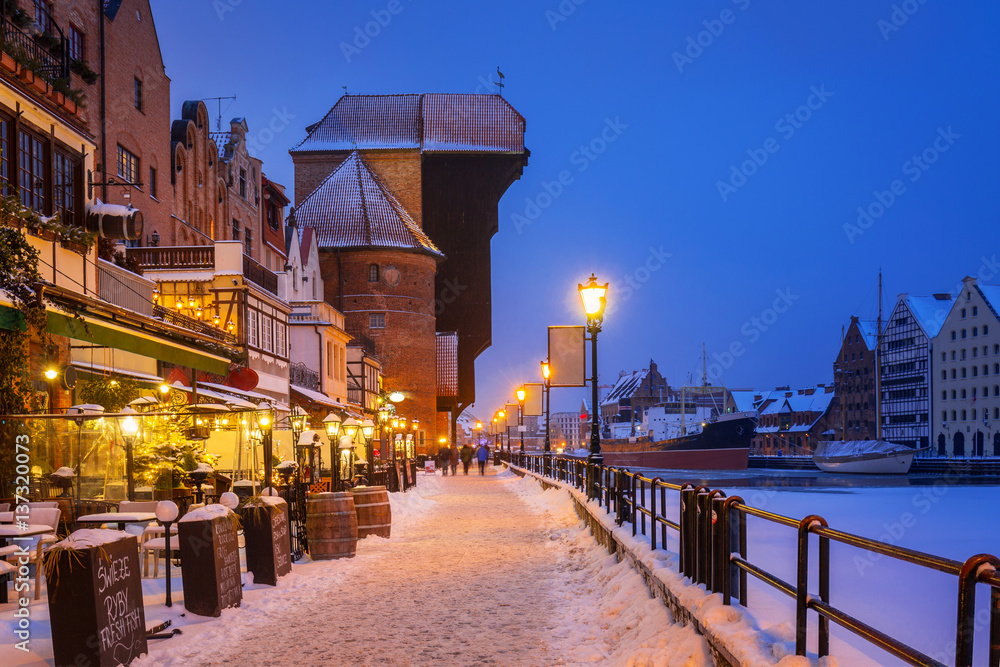 Fototapeta premium Medieval port crane at Motława river in snowy Gdansk, Poland