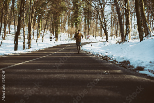 Athletic young man running in the nature. Healthy lifestyle - burning calories