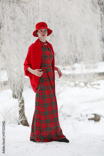 Girl in a red hat walks in Winter Park