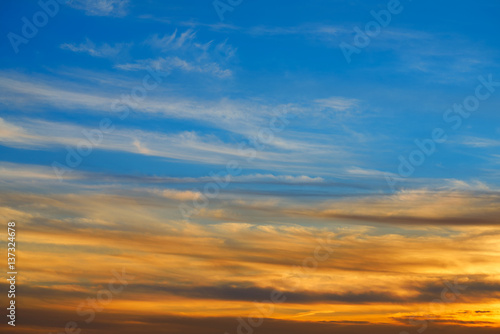 Sunset sky orange clouds over blue