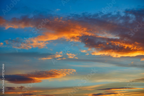 Sunset sky orange clouds over blue